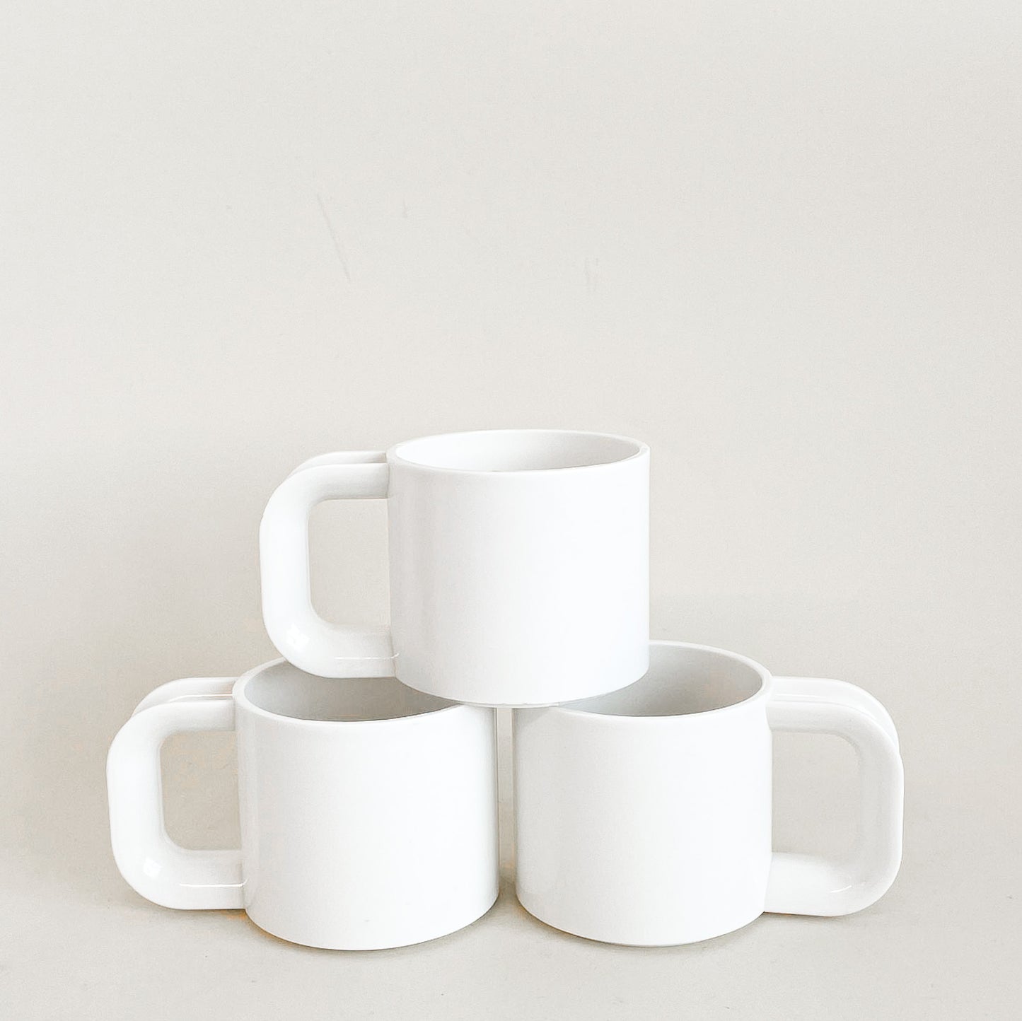 White plastic mugs trio