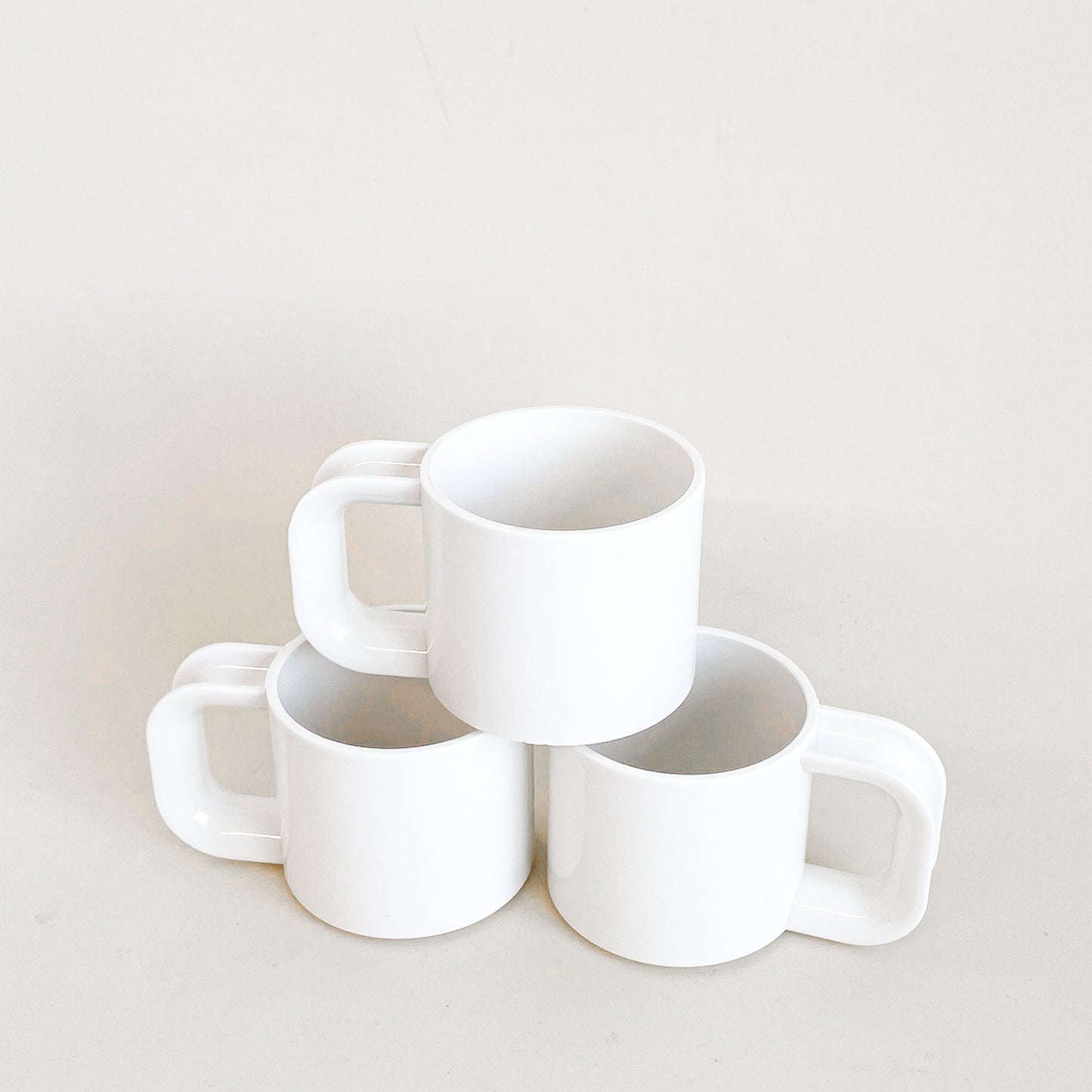 White plastic mugs trio