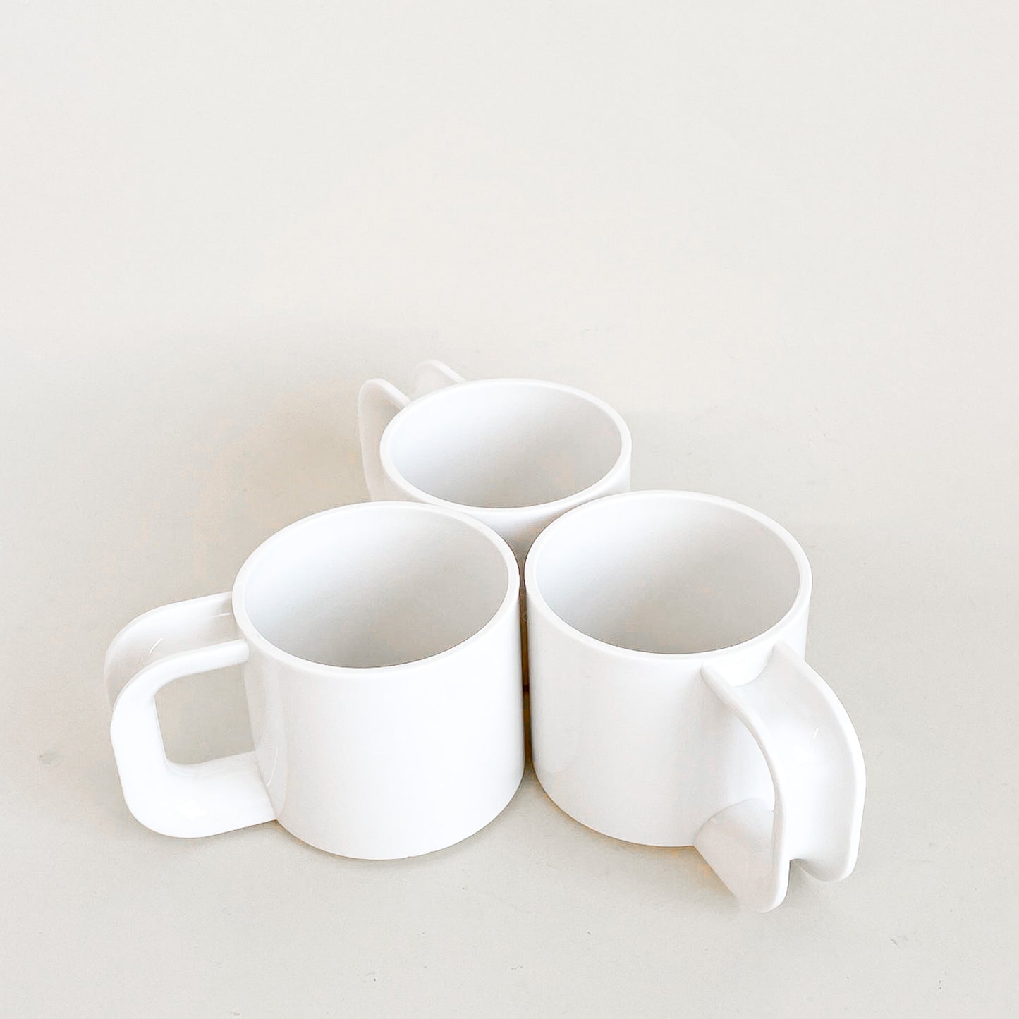 White plastic mugs trio