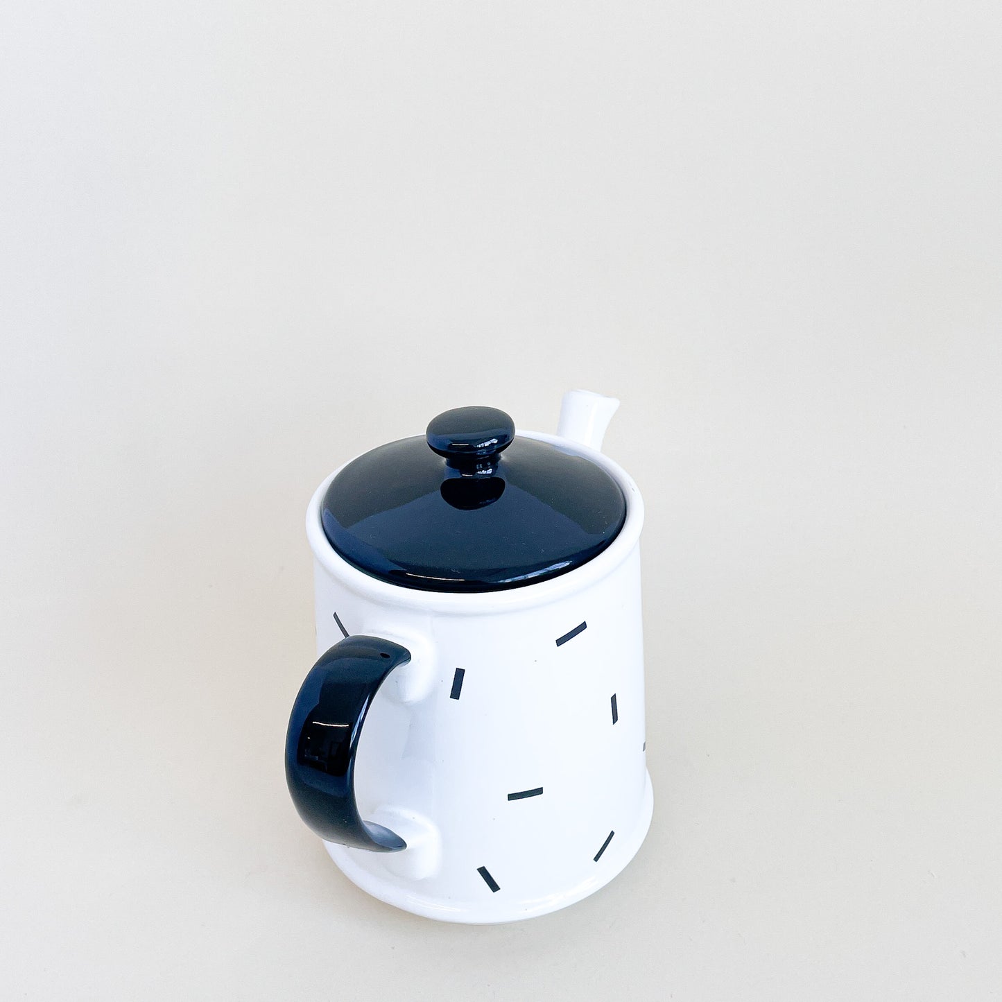 White teapot with black confetti