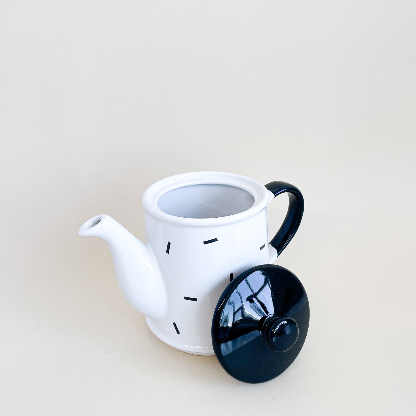 White teapot with black confetti