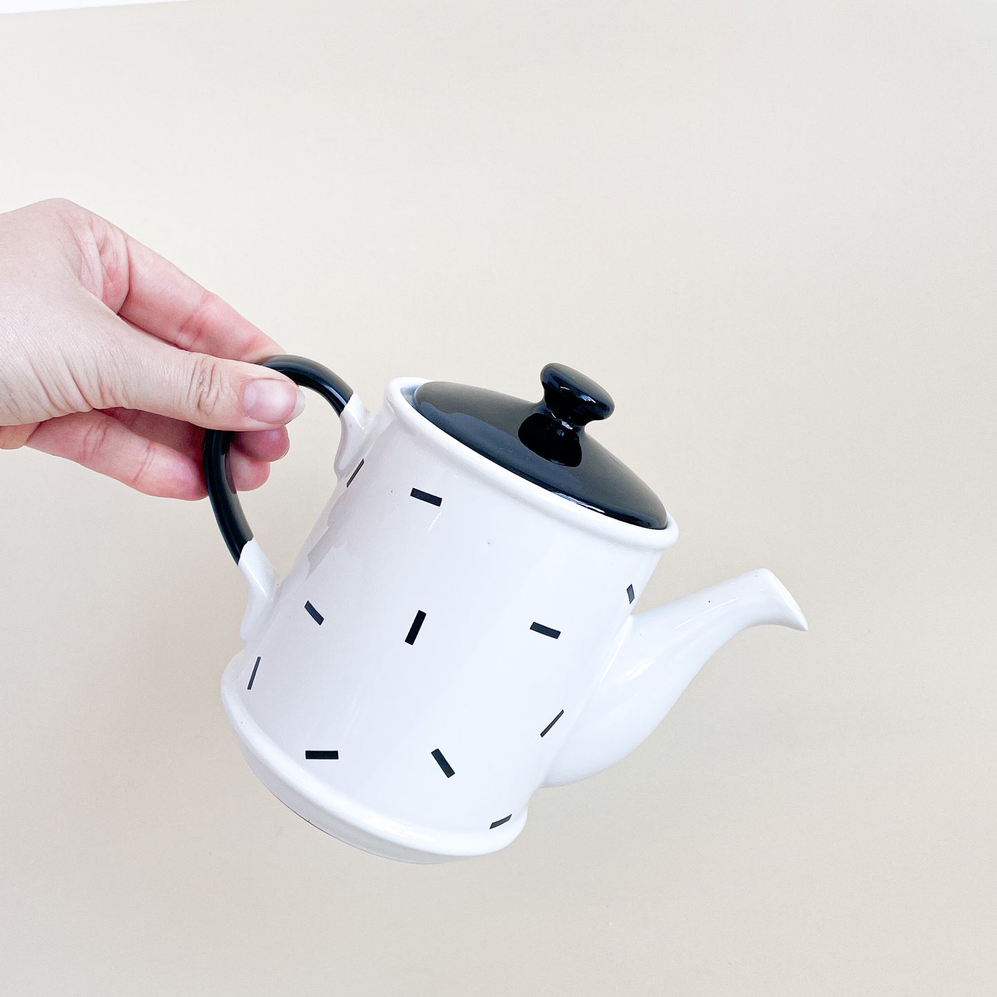 White teapot with black confetti