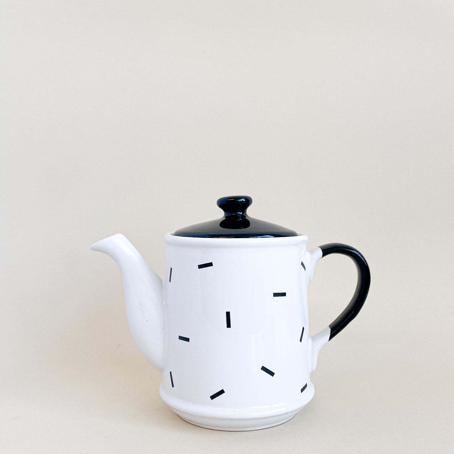 White teapot with black confetti