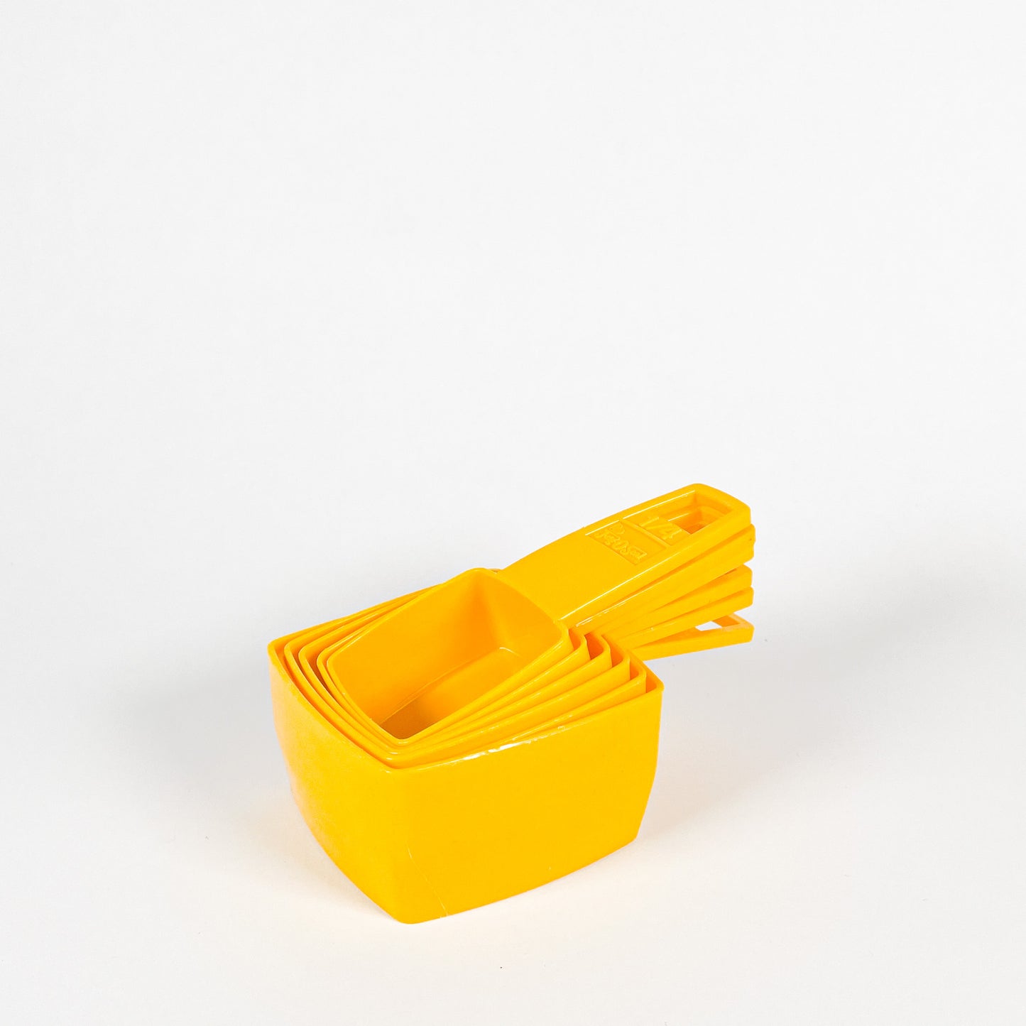 Yellow Frig-O-Seal measuring cups