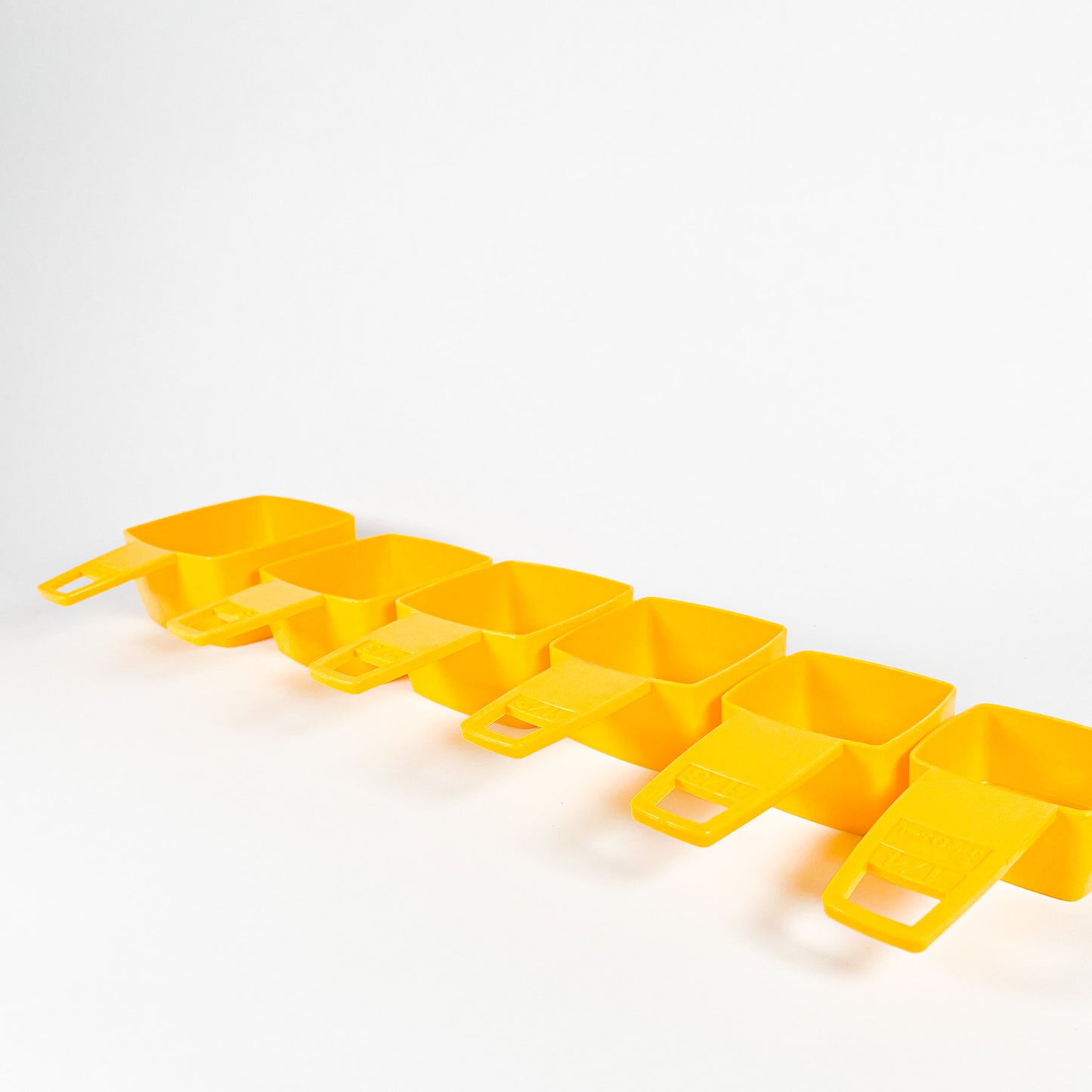 Yellow Frig-O-Seal measuring cups
