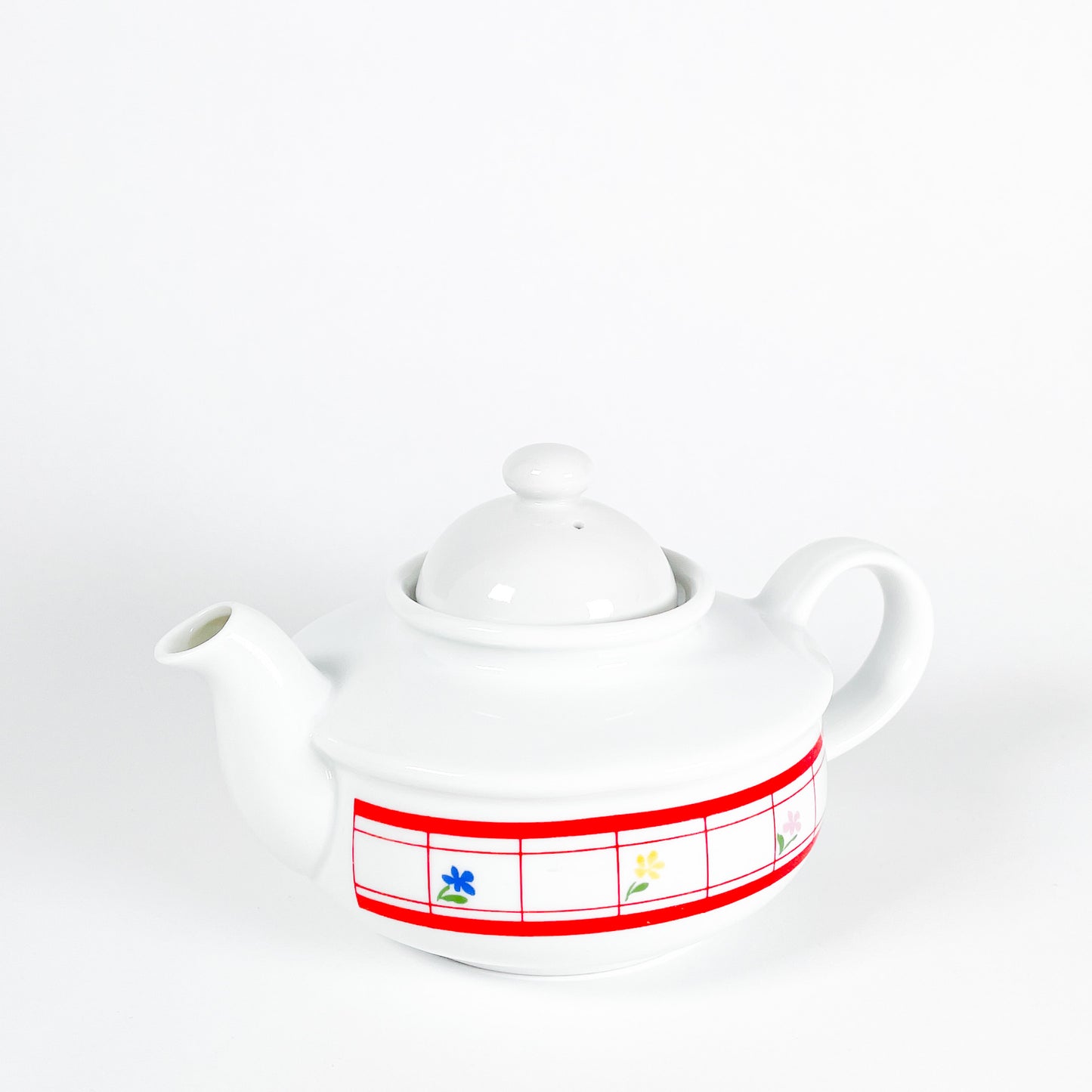 Red checkered teapot with small flowers