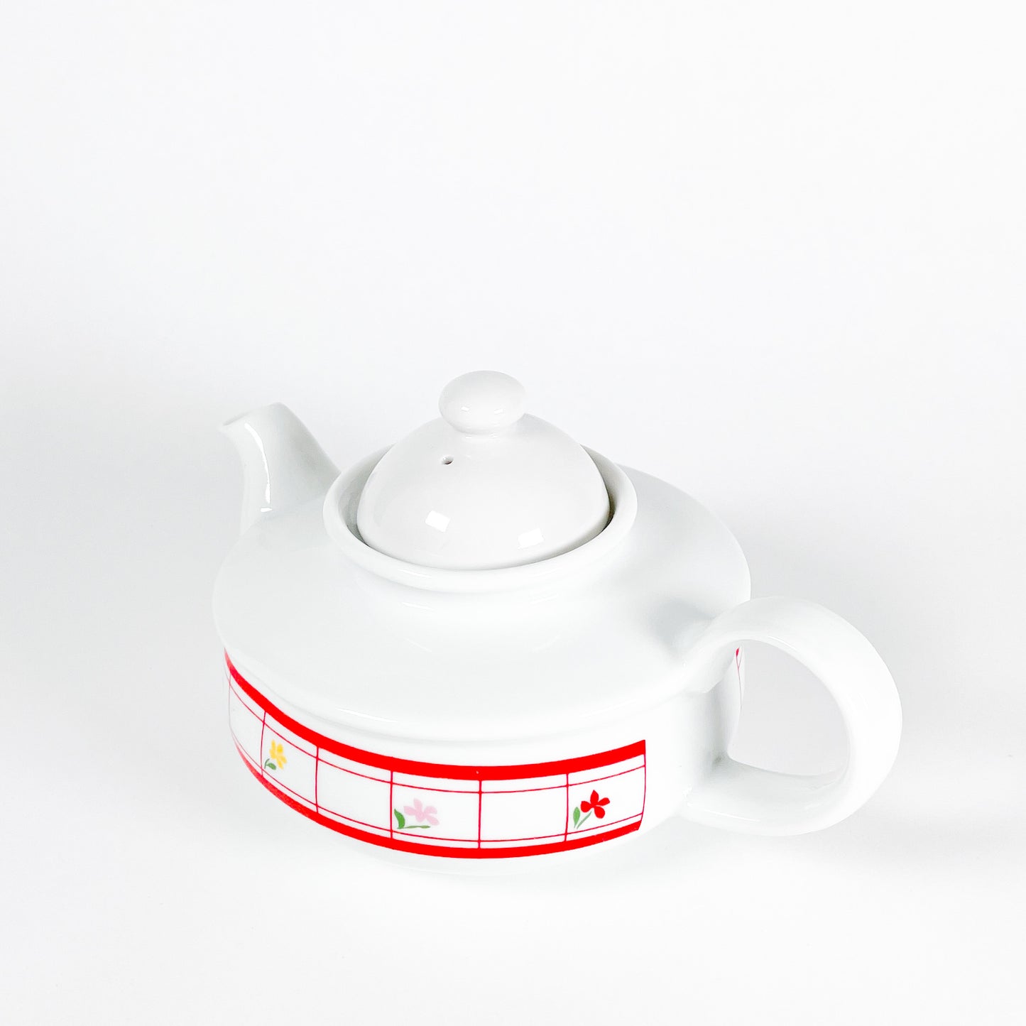 Red checkered teapot with small flowers