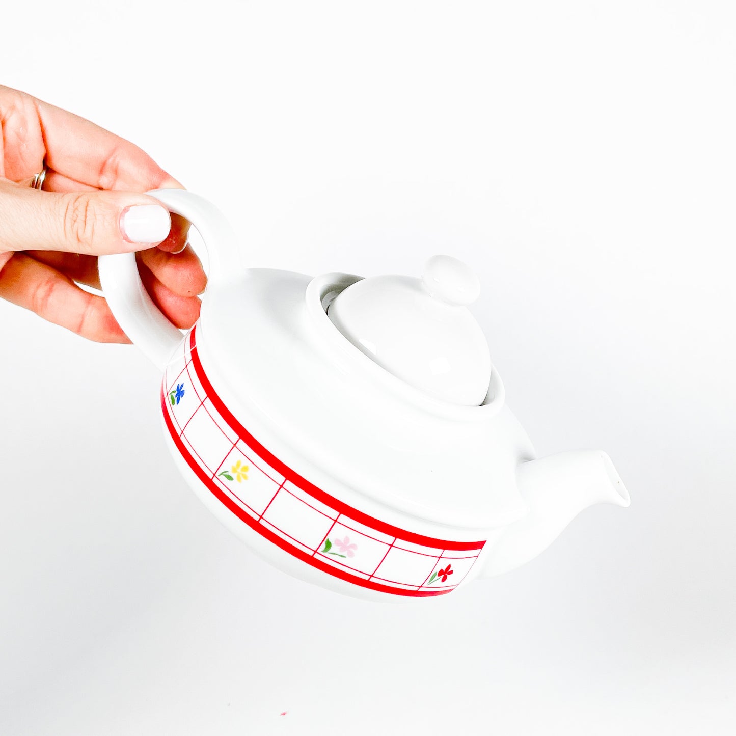 Red checkered teapot with small flowers