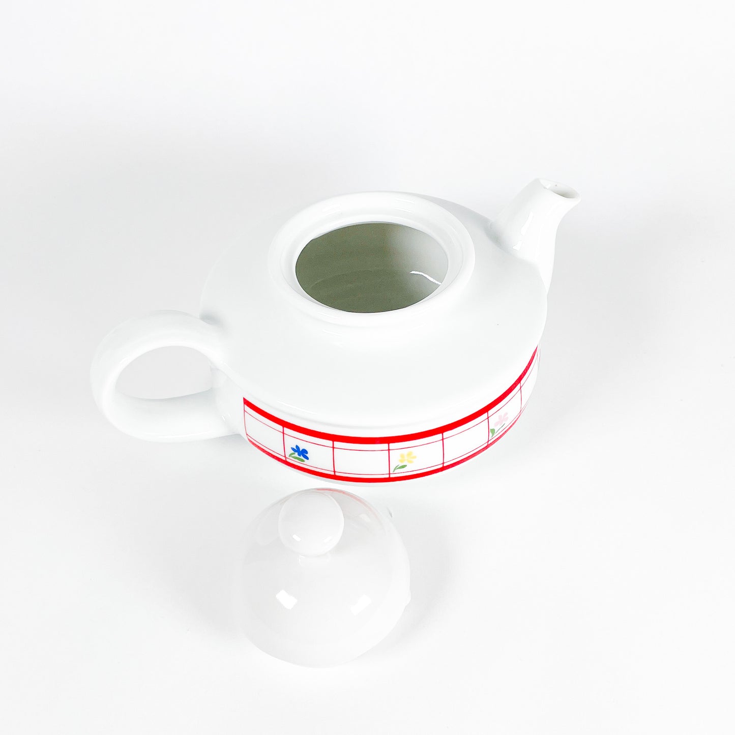 Red checkered teapot with small flowers