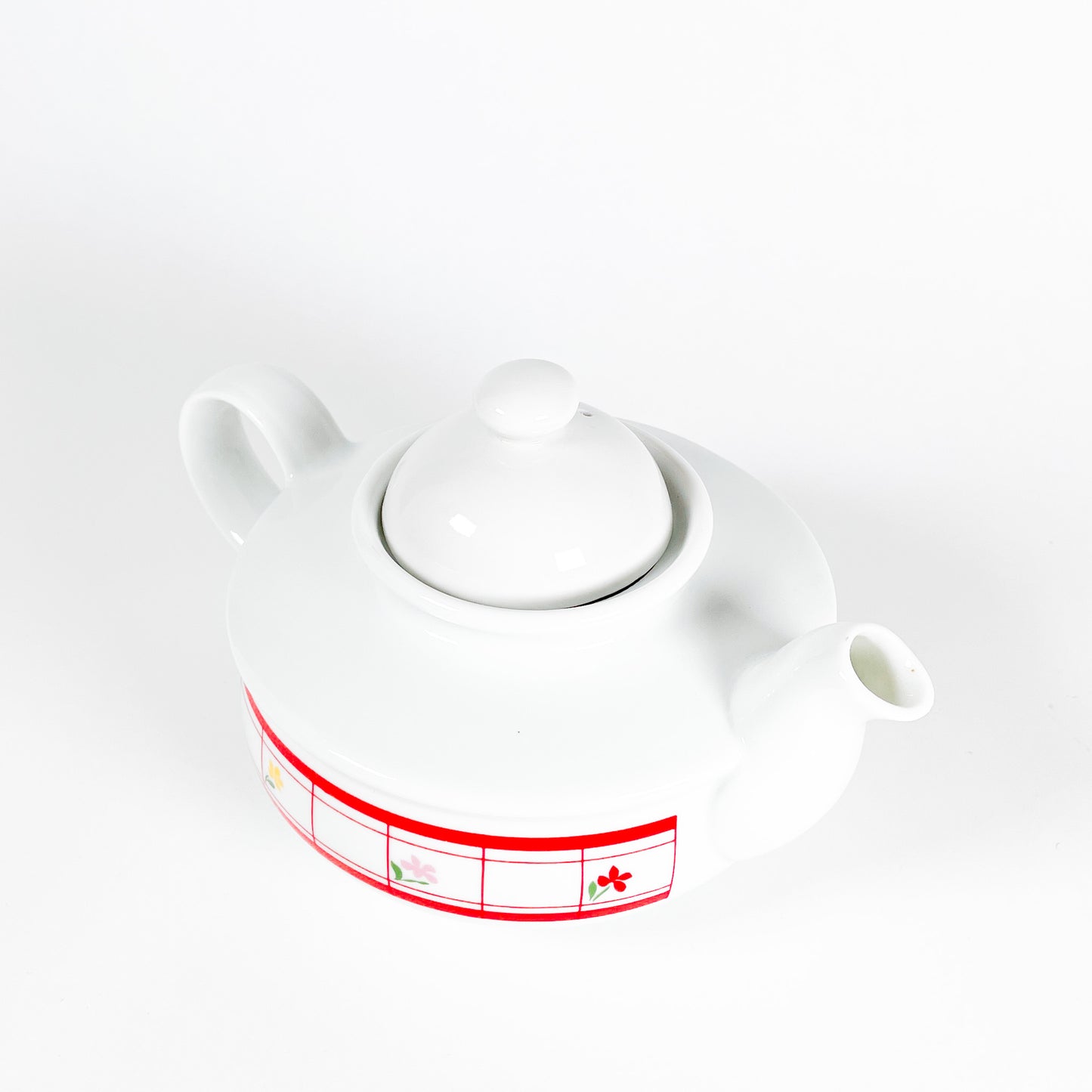 Red checkered teapot with small flowers