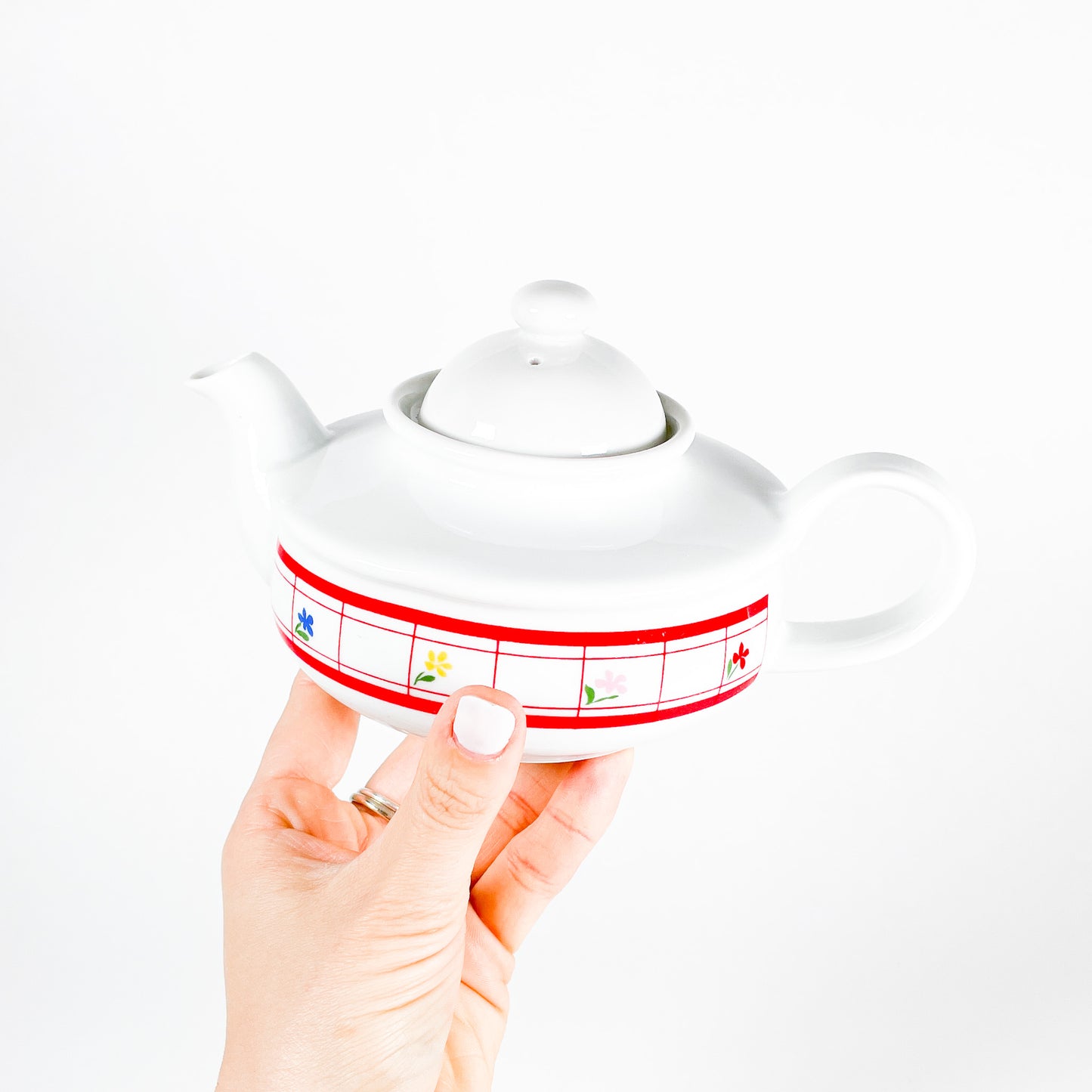 Red checkered teapot with small flowers