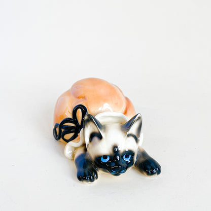 Little ceramic cat in a bag