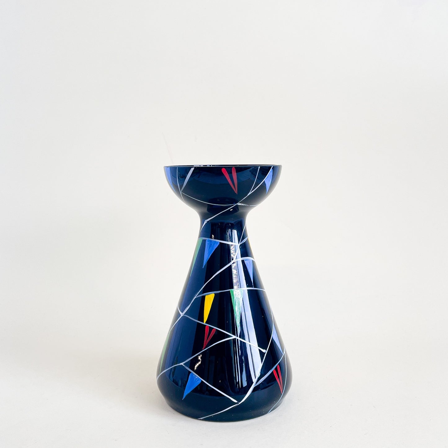 Black vase with colored triangles