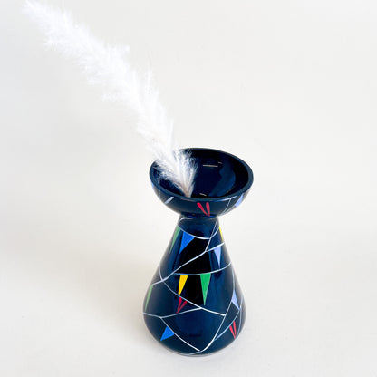 Black vase with colored triangles