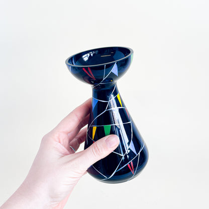 Black vase with colored triangles