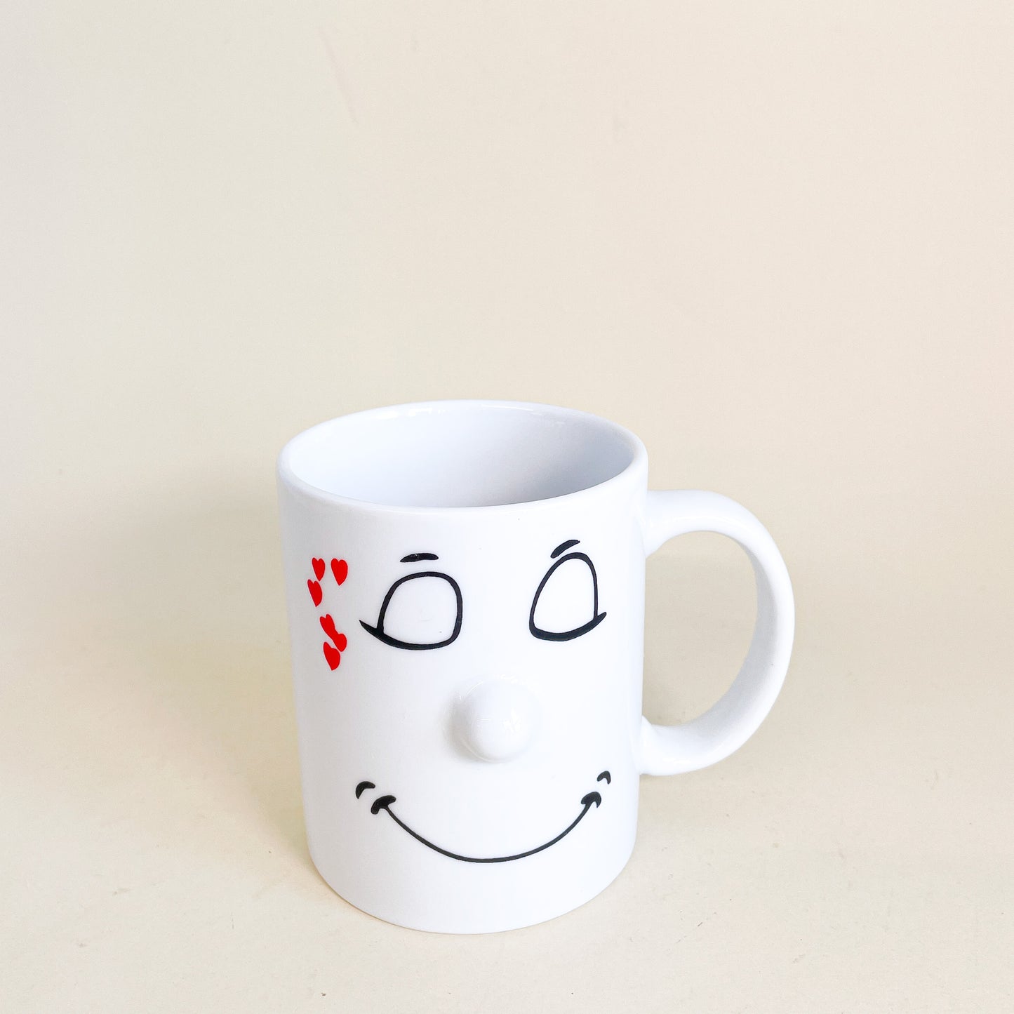 White mug face with hearts