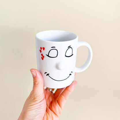 White mug face with hearts