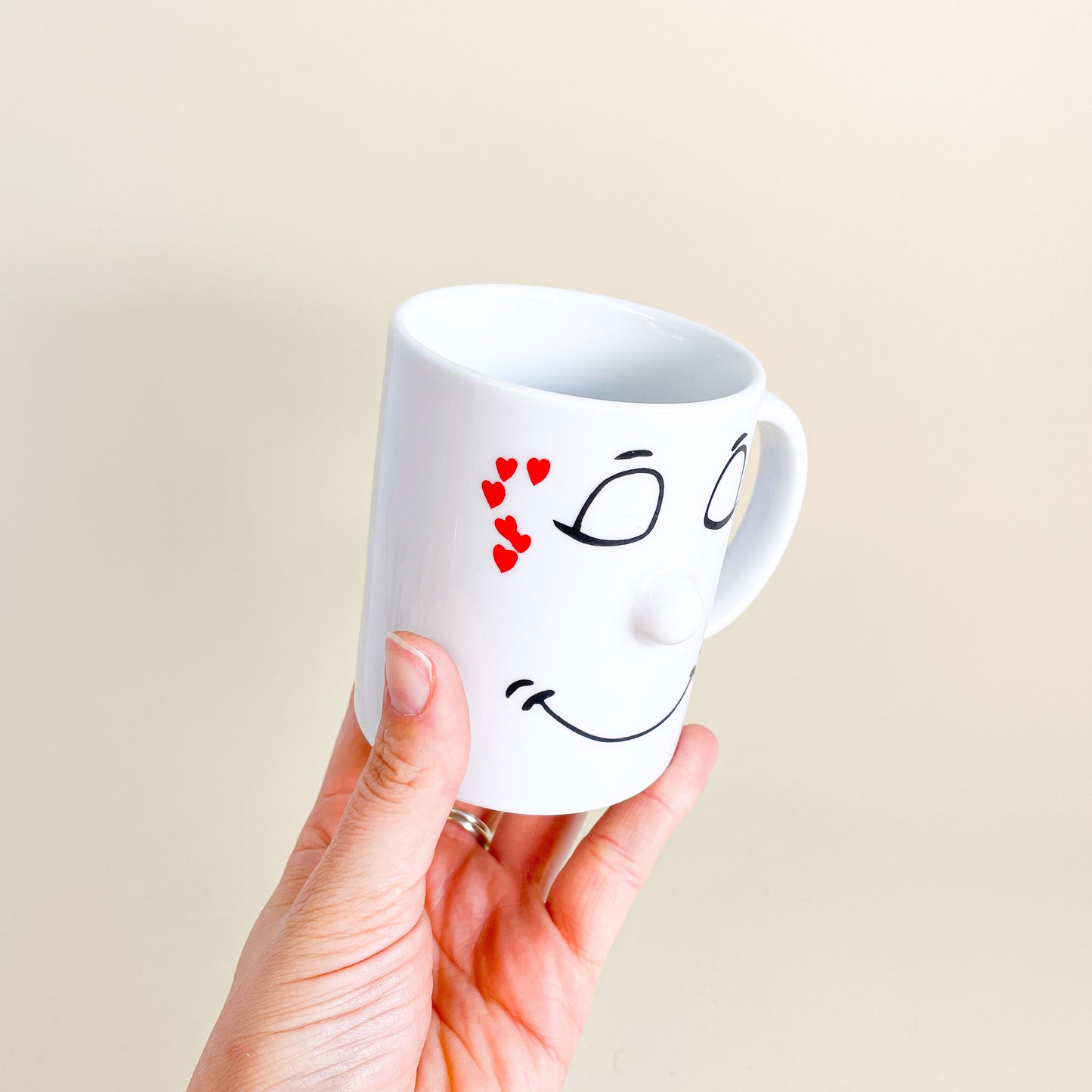 White mug face with hearts