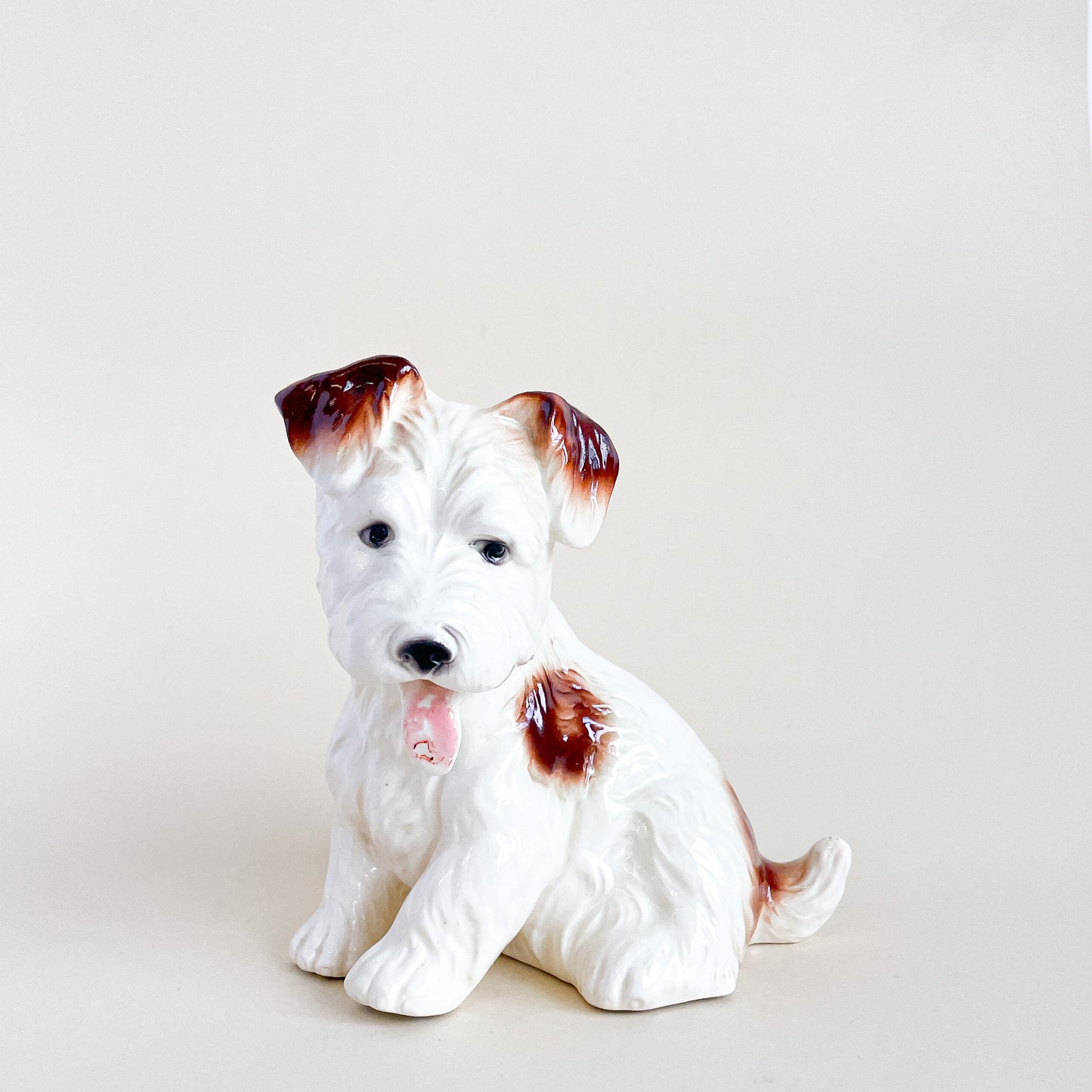 White and brown ceramic dog