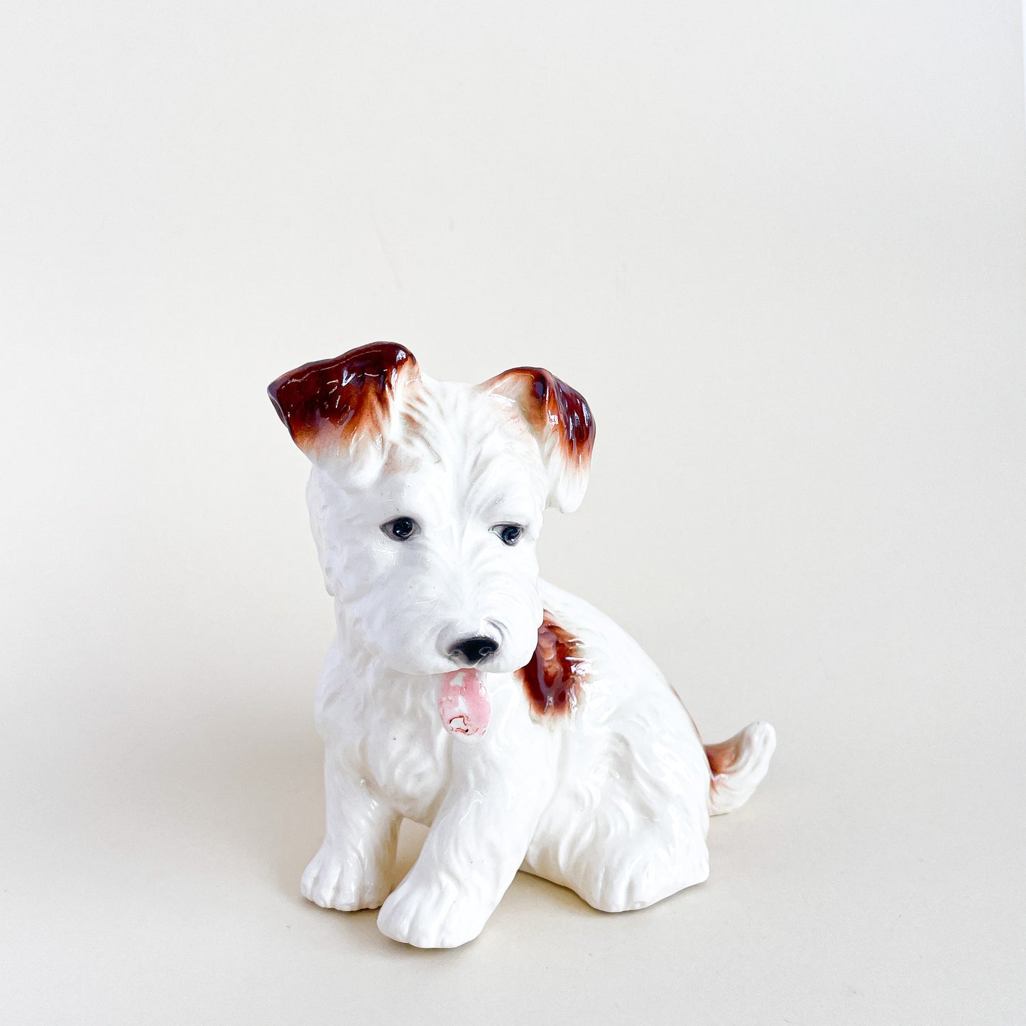 White and brown ceramic dog