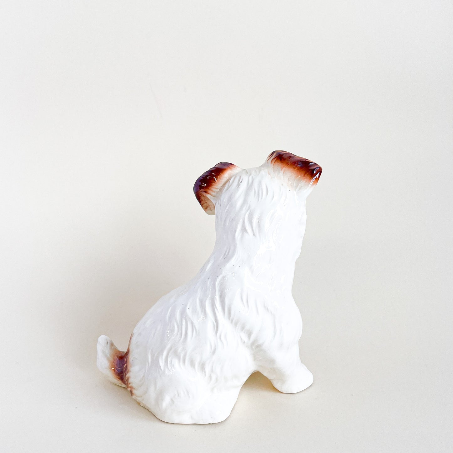 White and brown ceramic dog