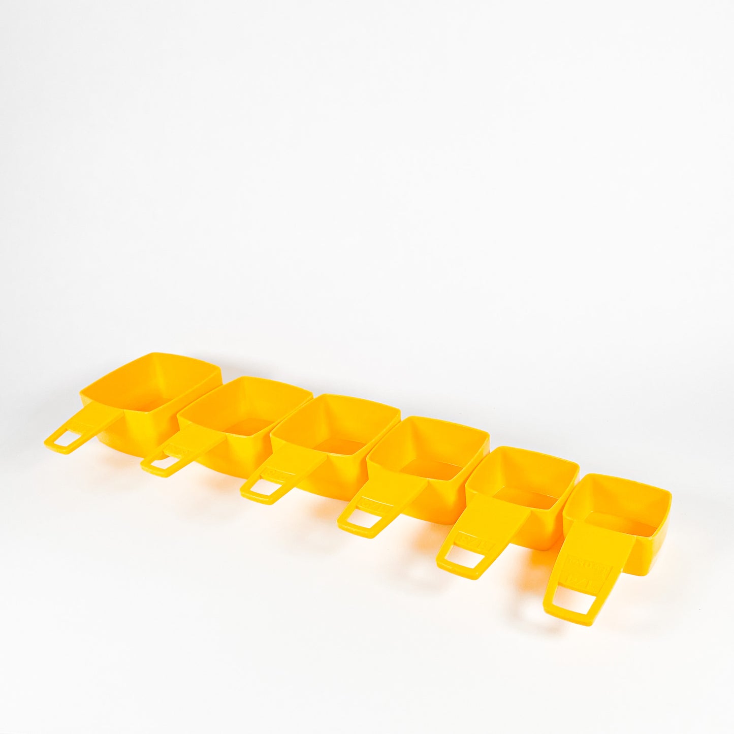 Yellow Frig-O-Seal measuring cups 