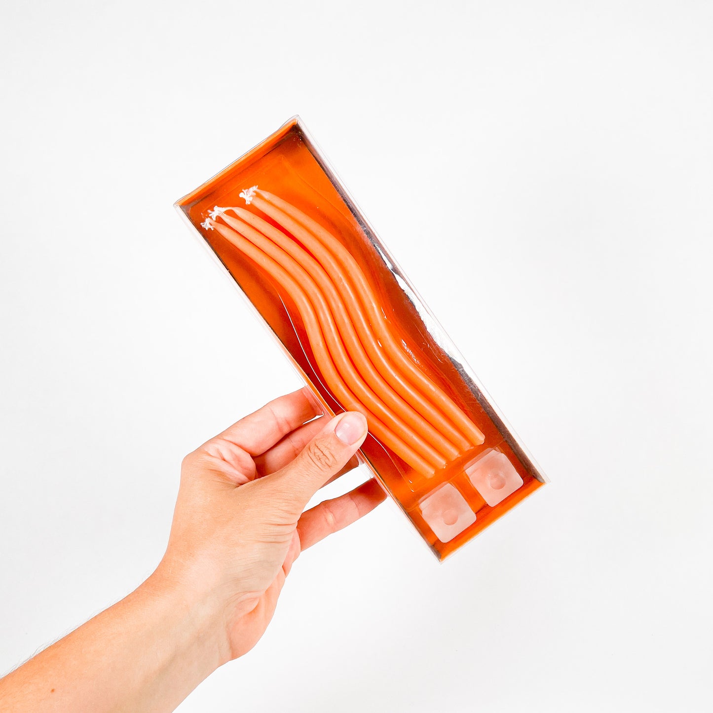 Thin orange squiggly taper candles