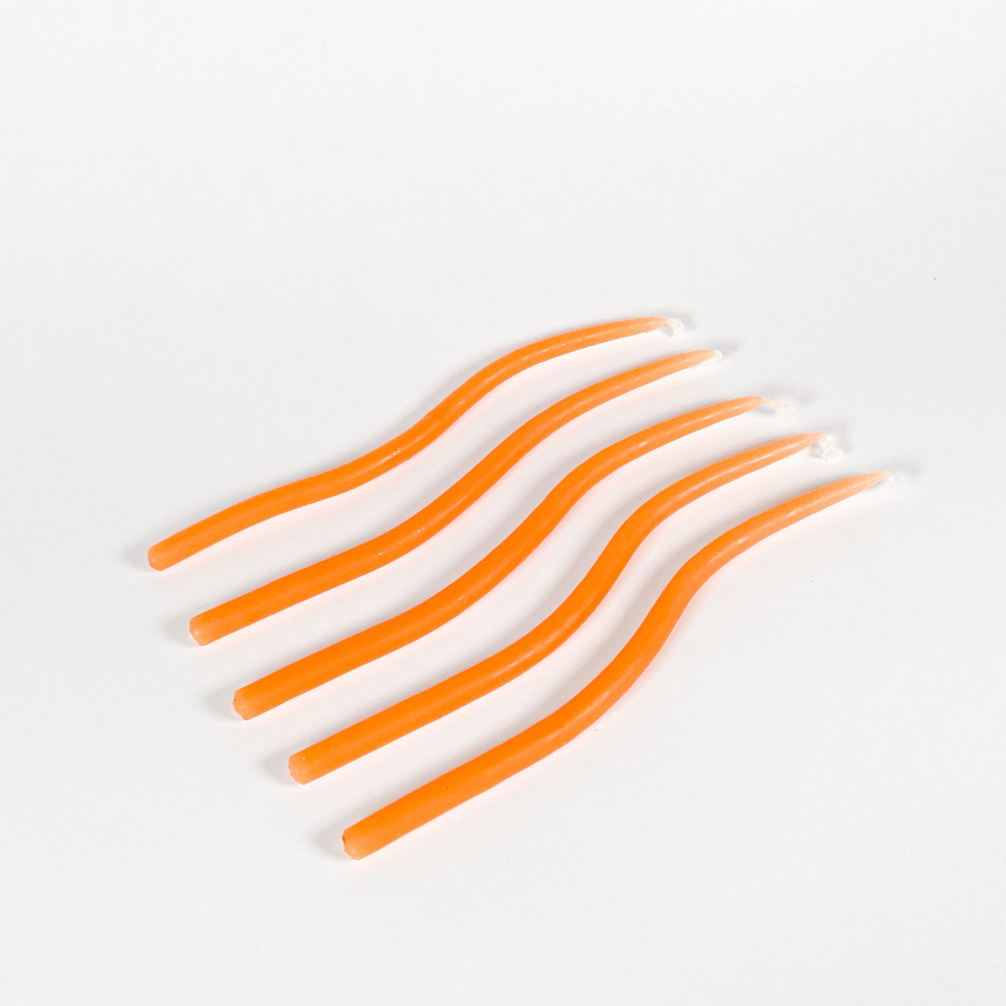 Thin orange squiggly taper candles