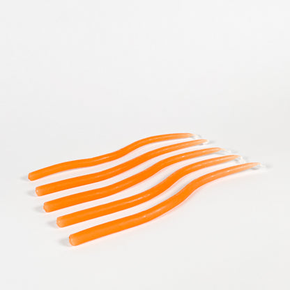 Thin orange squiggly taper candles