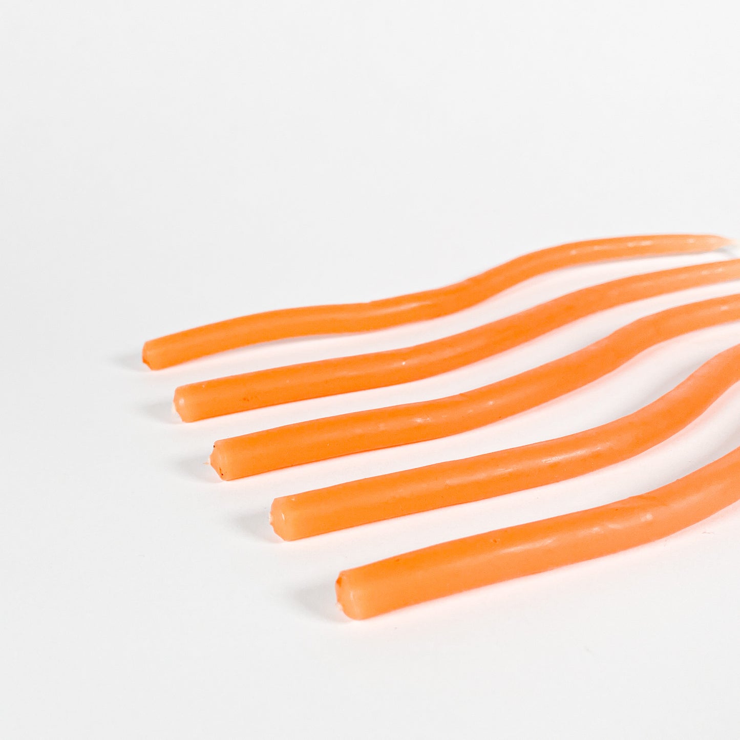 Thin orange squiggly taper candles