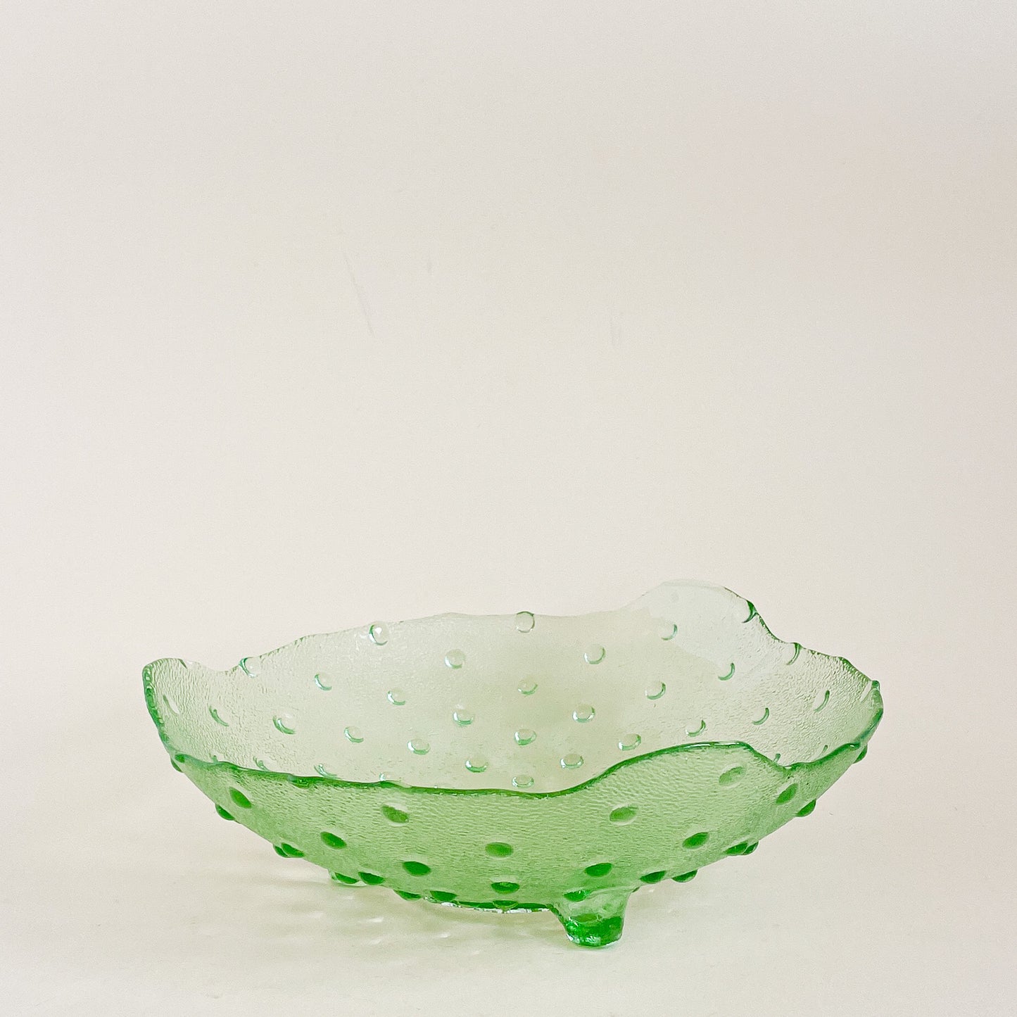 Green hobnail footed glass bowl