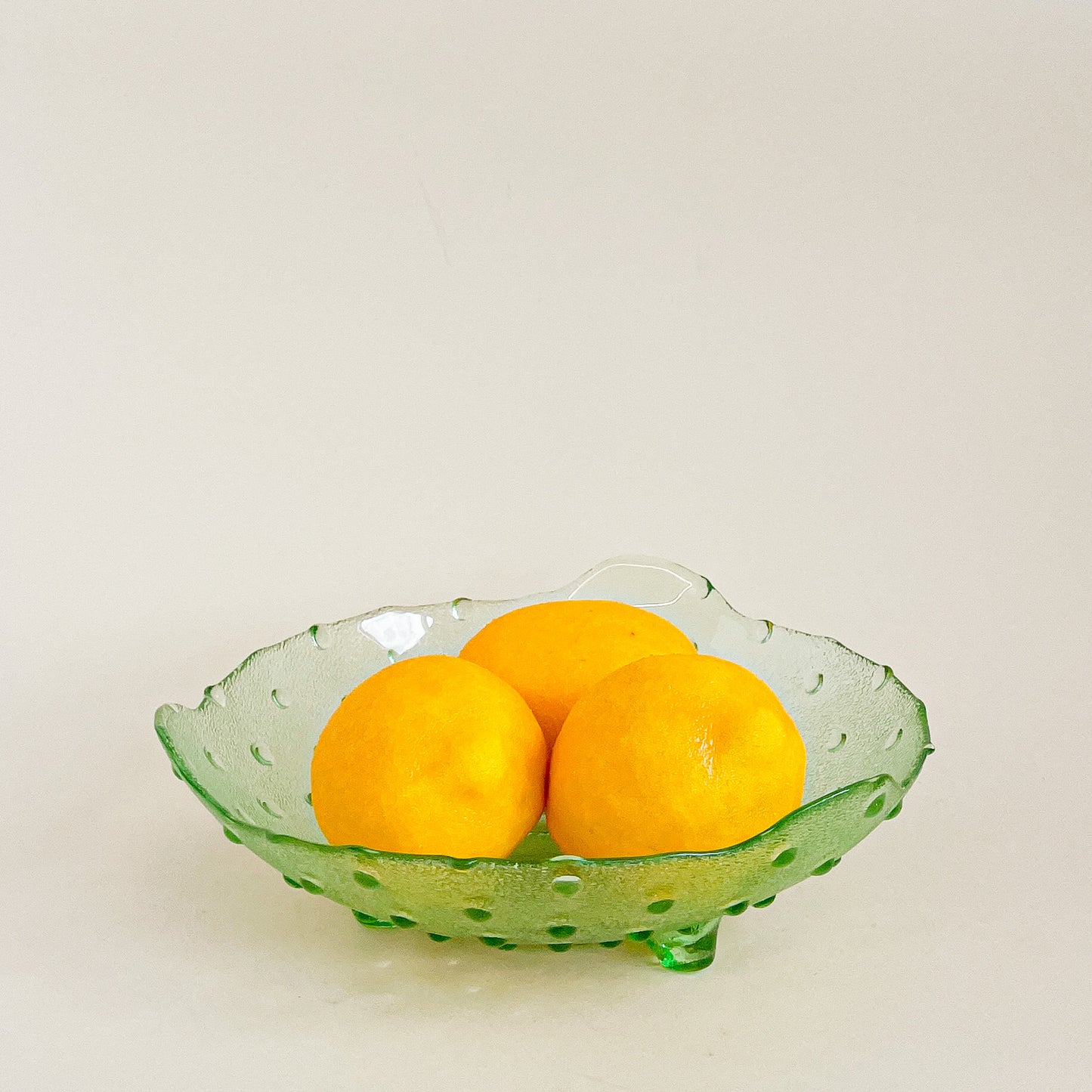 Green hobnail footed glass bowl