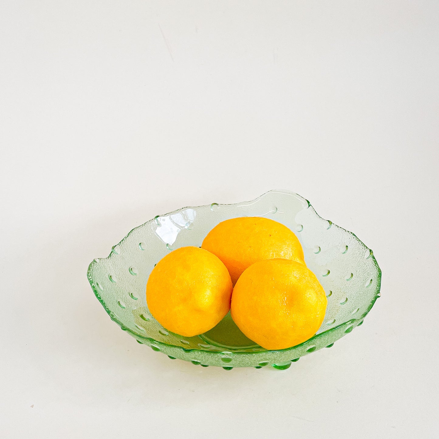 Green hobnail footed glass bowl