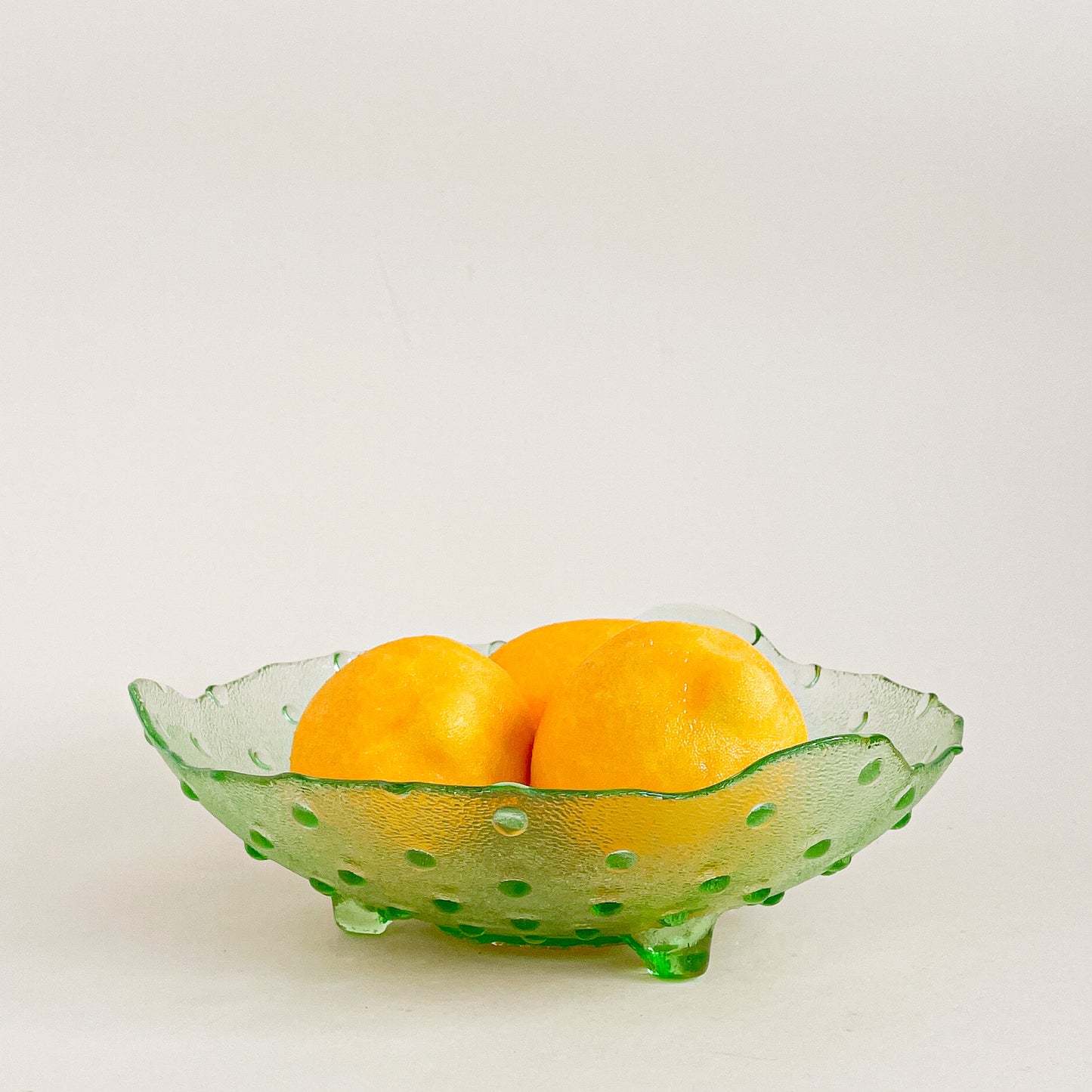 Green hobnail footed glass bowl