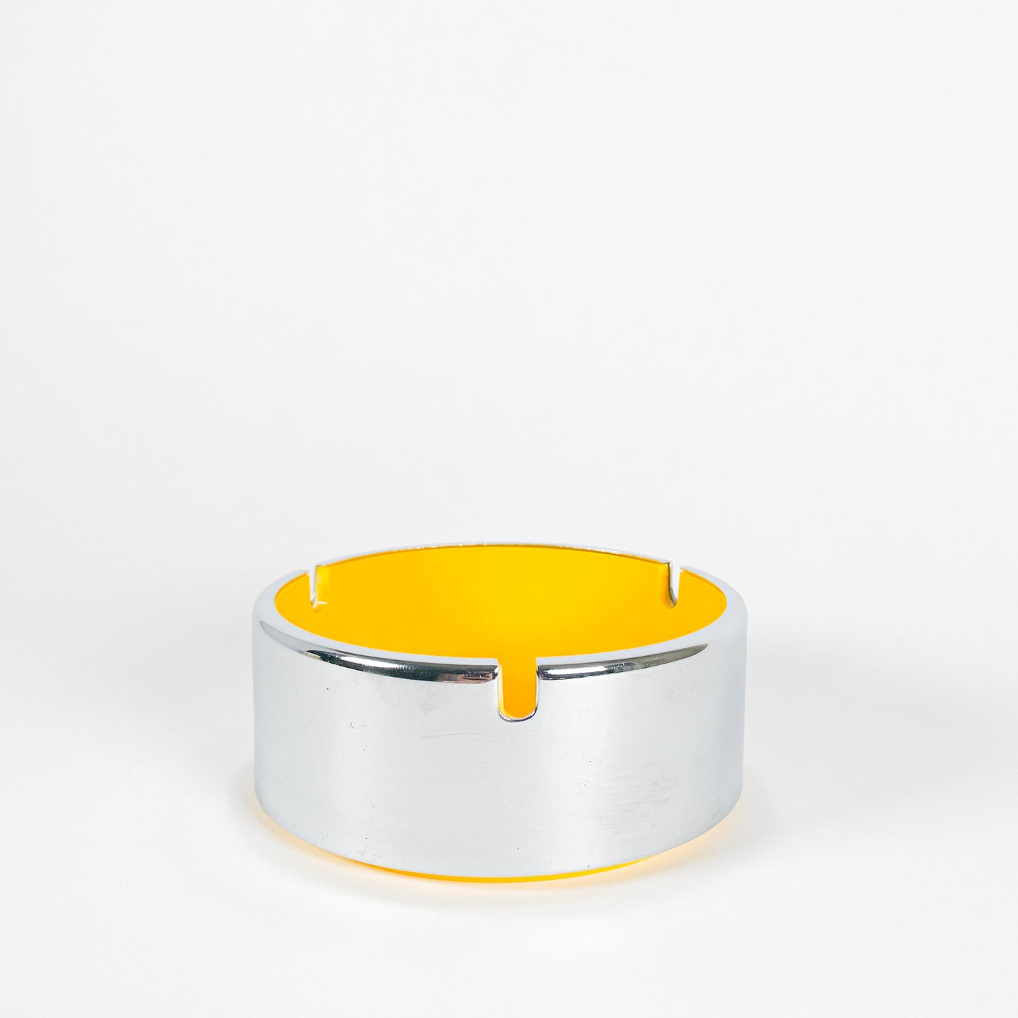 Silver and yellow ashtray dish