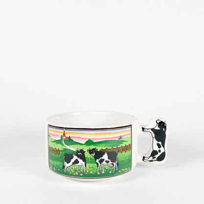 Cows looking towards a house mug