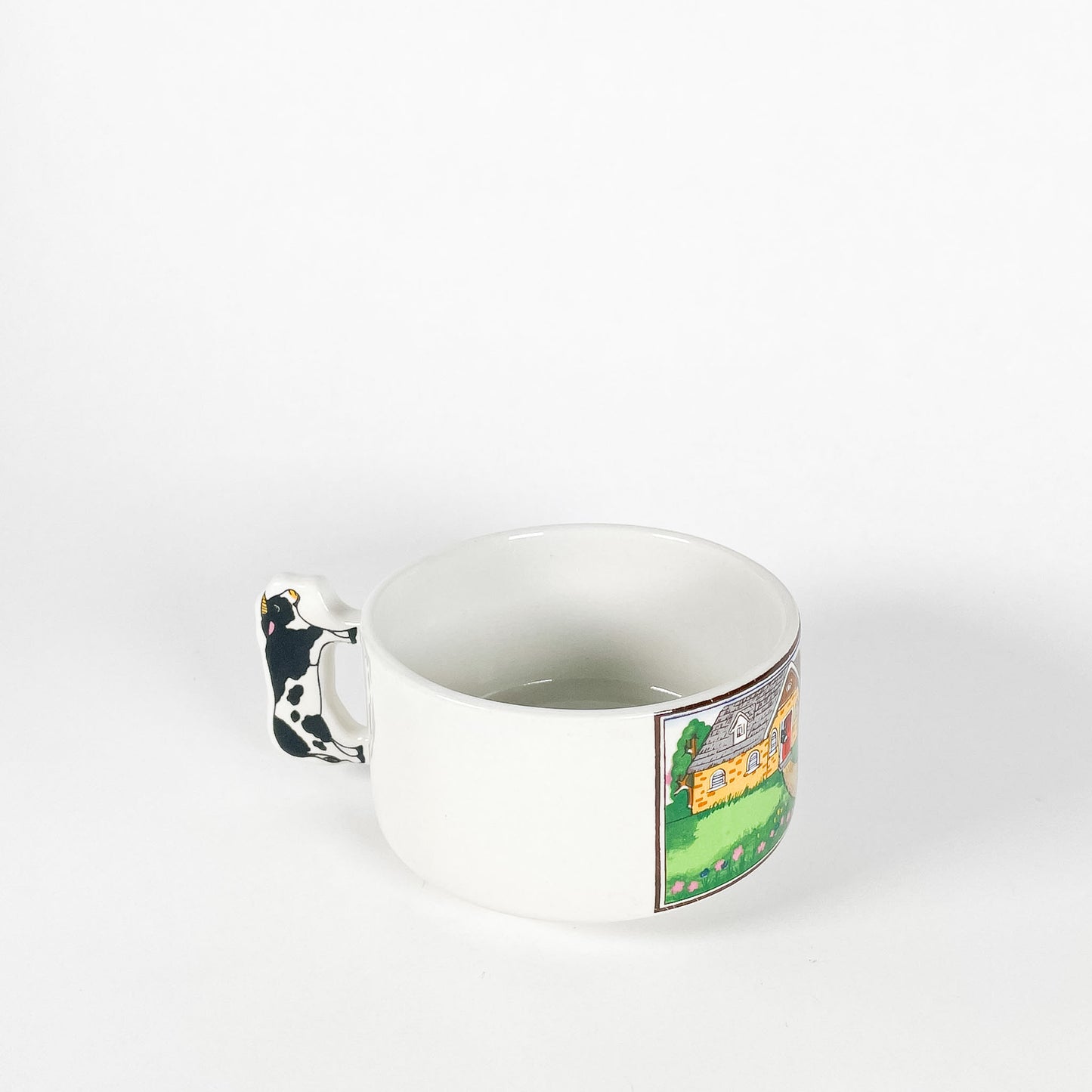 Cow in front of a house mug